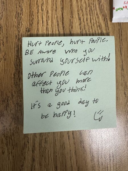 Handwritten sticky note with words of encouragement